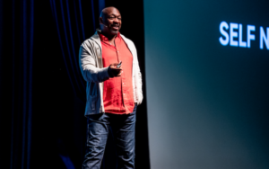 Actor Alton Fitzgerald White motions onstage